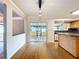 Open kitchen area featuring hardwood floors, modern lighting, and sliding glass doors to the lanai at 4030 Braesgate Ln, Tampa, FL 33624