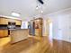 Spacious kitchen with island, stainless steel refrigerator, and light wood cabinets and hardwoods at 4030 Braesgate Ln, Tampa, FL 33624