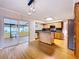 Bright kitchen featuring an island, wood cabinets, stainless steel appliances, and sliding glass doors to the lanai at 4030 Braesgate Ln, Tampa, FL 33624