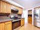 Kitchen featuring stainless steel appliances, granite countertops, and light wood cabinets at 4030 Braesgate Ln, Tampa, FL 33624
