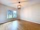Bright living room featuring hardwood floors and a view of the outdoor greenery from a large window at 4030 Braesgate Ln, Tampa, FL 33624