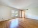 Living room featuring hardwood floors, a large window, and light-colored walls at 4030 Braesgate Ln, Tampa, FL 33624