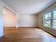 Open living room with beautiful hardwood floors and natural light streaming through a large window at 4030 Braesgate Ln, Tampa, FL 33624