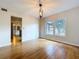 Open floor plan with view of the modern light fixture and the exterior greenery at 4030 Braesgate Ln, Tampa, FL 33624