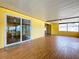Enclosed patio featuring sliding glass doors, laminate flooring, and bright yellow walls for a sunny feel at 4030 Braesgate Ln, Tampa, FL 33624