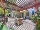 View of covered patio featuring tiled flooring and view of the 2-car garage at 4030 Braesgate Ln, Tampa, FL 33624