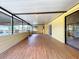 Spacious enclosed patio with laminate floors and sliding doors, offering a versatile living space at 4030 Braesgate Ln, Tampa, FL 33624