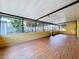 Bright and airy enclosed patio with laminate floors and large windows providing ample natural light and backyard views at 4030 Braesgate Ln, Tampa, FL 33624