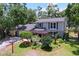 Aerial side view of the home features a lush landscaped yard and charming outdoor space at 4030 Braesgate Ln, Tampa, FL 33624