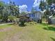 Side yard view shows the home's well-maintained lawn and mature landscaping at 4030 Braesgate Ln, Tampa, FL 33624