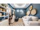 Inviting living room with blue walls, stylish decor, built-in shelves, and comfortable seating at 4294 Cairoli Ct, Wesley Chapel, FL 33543