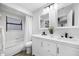 Bright bathroom with a double vanity, tub and shower combo, tile flooring, and modern fixtures at 4391 Ne Cherry Ne St, St Petersburg, FL 33703