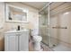 Bathroom featuring a glass door shower, sink, and toilet at 4391 Ne Cherry Ne St, St Petersburg, FL 33703