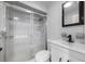 Bathroom featuring a glass door shower, sink, and toilet at 4391 Ne Cherry Ne St, St Petersburg, FL 33703