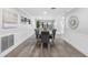 Dining room with seating for six, hardwood floors, wainscoting and bright lighting at 4391 Ne Cherry Ne St, St Petersburg, FL 33703