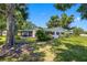 Charming single-story home with a screened lanai, well-maintained lawn, and mature shade trees at 4391 Ne Cherry Ne St, St Petersburg, FL 33703