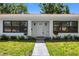 Charming home with white exterior, manicured landscaping, and inviting entryway at 4391 Ne Cherry Ne St, St Petersburg, FL 33703