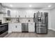 Kitchen featuring stainless steel appliances, white cabinets, and lovely countertops and backsplash at 4391 Ne Cherry Ne St, St Petersburg, FL 33703