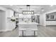 Bright kitchen features a large island with seating and white cabinets for ample storage at 4391 Ne Cherry Ne St, St Petersburg, FL 33703