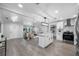 Open floor plan showing kitchen flowing into living room with hardwood floors and stylish décor at 4391 Ne Cherry Ne St, St Petersburg, FL 33703