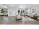 Inviting living room with comfortable seating, natural light, and seamless flow to the dining area at 4391 Ne Cherry Ne St, St Petersburg, FL 33703