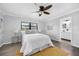 Main bedroom featuring an ensuite bathroom, ceiling fan, light gray walls and light-colored floors at 4391 Ne Cherry Ne St, St Petersburg, FL 33703