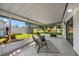 Screened-in porch with tile flooring, seating, and a view of the backyard at 4391 Ne Cherry Ne St, St Petersburg, FL 33703