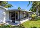 Relaxing screened-in porch provides outdoor living space with tiled floor and views of the backyard at 4391 Ne Cherry Ne St, St Petersburg, FL 33703