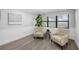 Sitting room features natural light, with two chairs and plants creating a peaceful ambiance at 4391 Ne Cherry Ne St, St Petersburg, FL 33703