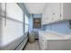 Utility room with storage cabinets and a window at 4391 Ne Cherry Ne St, St Petersburg, FL 33703
