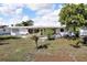 View of backyard of home, including the covered patio with access to the house at 525 Skylark Nw Ln, Port Charlotte, FL 33952