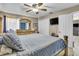 Comfortable bedroom featuring a ceiling fan, tv, closet, and large dresser with mirror at 525 Skylark Nw Ln, Port Charlotte, FL 33952