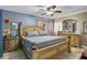 Bedroom featuring a large bed with wood frame, tile floor and blue accent wall at 525 Skylark Nw Ln, Port Charlotte, FL 33952