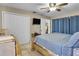Bedroom featuring a large bed with wood frame, tile floor, TV and a closet with bi-fold doors at 525 Skylark Nw Ln, Port Charlotte, FL 33952