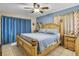 Bedroom featuring a large bed with wood frame, tile floor and blue accent wall at 525 Skylark Nw Ln, Port Charlotte, FL 33952