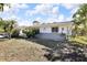 Home with a well-kept lawn and a charming exterior, accented by lush landscaping at 525 Skylark Nw Ln, Port Charlotte, FL 33952