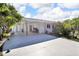 Exterior of home featuring carport, with a well-maintained yard and mature plantings at 525 Skylark Nw Ln, Port Charlotte, FL 33952