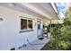 Charming home entrance with decorative details and lush landscaping at 525 Skylark Nw Ln, Port Charlotte, FL 33952