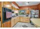 Well-lit kitchen features ample cabinet space, stainless steel appliances, and tile flooring at 525 Skylark Nw Ln, Port Charlotte, FL 33952