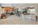 Open floor plan living area featuring tile floors, ceiling fan and sliding glass doors providing access to the backyard at 525 Skylark Nw Ln, Port Charlotte, FL 33952