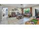 Spacious living room featuring neutral tones, tile flooring, and ample seating at 525 Skylark Nw Ln, Port Charlotte, FL 33952