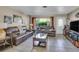 Comfortable living room with tile floors, large window, and cozy seating at 525 Skylark Nw Ln, Port Charlotte, FL 33952