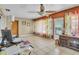 Bright living room with tile floors, ceiling fan and large windows dressed with colored semi-sheer curtains at 525 Skylark Nw Ln, Port Charlotte, FL 33952