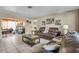 Inviting living room with tile flooring, comfortable seating, and access to the backyard at 525 Skylark Nw Ln, Port Charlotte, FL 33952
