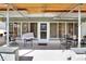 Covered patio area with seating, featuring access to the home through sliding glass doors at 525 Skylark Nw Ln, Port Charlotte, FL 33952