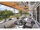 Covered patio with outdoor furniture, offering a relaxing view of the backyard and greenery at 525 Skylark Nw Ln, Port Charlotte, FL 33952
