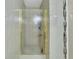 Bathroom featuring a glass door shower with white tile walls and decorative tile accents at 525 Skylark Nw Ln, Port Charlotte, FL 33952