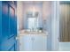 Cozy powder room featuring modern lighting, a stylish mirror, and a tranquil ambiance at 5253 Boardwalk St, Holiday, FL 34690
