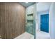 Chic bathroom with a bathtub, a blue accent wall, modern fixtures, and sleek design at 5253 Boardwalk St, Holiday, FL 34690