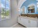 Elegant bathroom with double vanity, modern mirrors, stylish fixtures, and plenty of natural light at 5253 Boardwalk St, Holiday, FL 34690